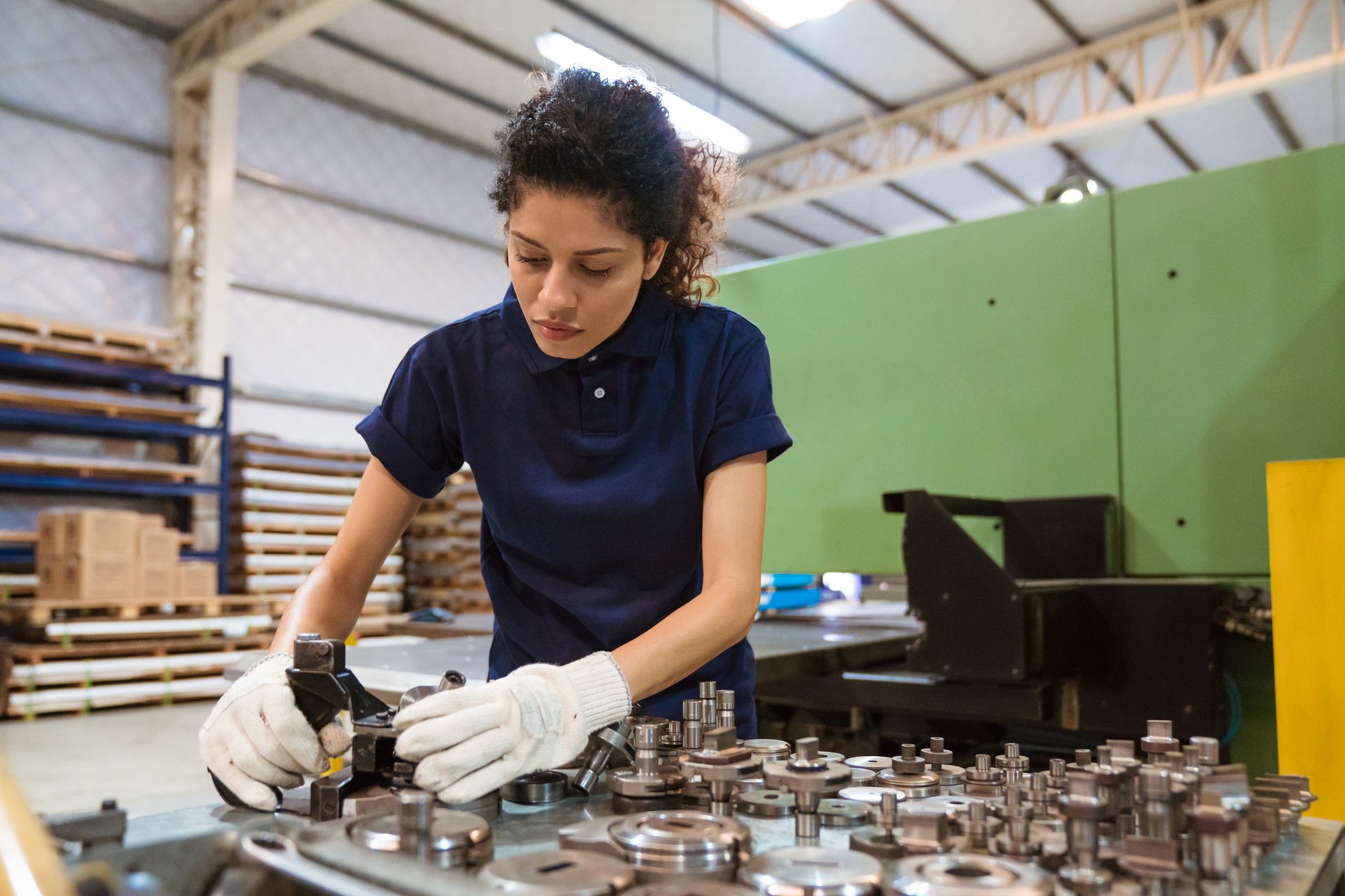 Trainee using manufacturing machinery